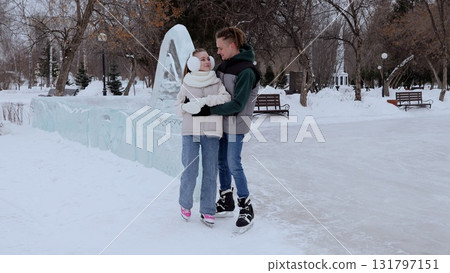 Romantic young couple gliding together on ice rink, surrounded by sparkling snow covered landscape and intricate ice sculptures, expressing tender connection and winter happiness Romantic young couple gliding together on ice rink, surrounded by sparkling snow covered landscape and intricate ice sculptures, expressing tender connection and winter happiness 131797151