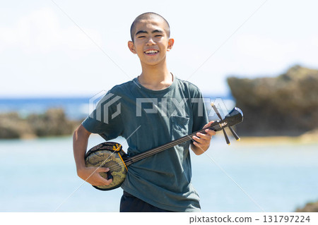 Okinawan people playing the sanshin on the beach in Okinawa 131797224