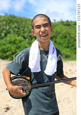 Okinawan people playing the sanshin on the beach in Okinawa 131797225