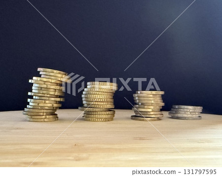 Macro photography of euro coins highlighting financial themes such as pensions, taxes, income, and losses. Money, economics, and financial literacy. Macro photography of euro coins highlighting financial themes such as pensions, taxes, income, and losses. Money, economics, and financial literacy. 131797595