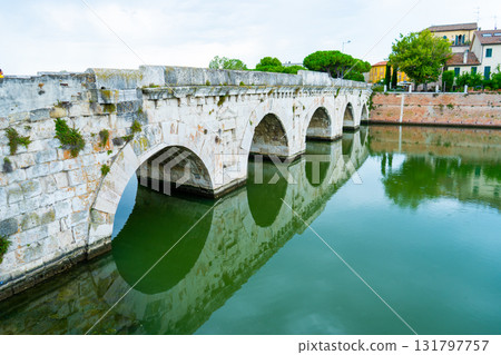 Tiberius Bridge over the river in Rimini. Italian classical architecture. A city landmark. Tiberius Bridge over the river in Rimini. Italian classical architecture. A city landmark. 131797757
