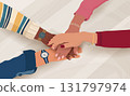 Hands joined together showing teamwork unity and agreement among diverse coworkers 131797974