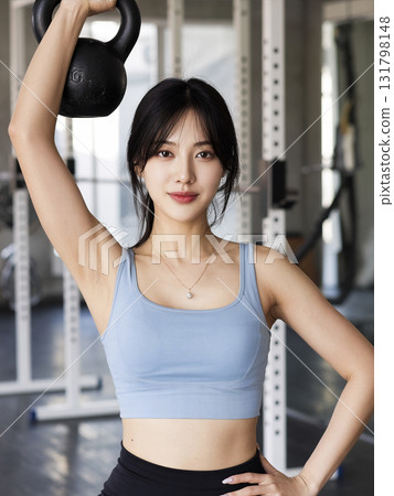 Woman is holding a kettlebell in her right hand Woman is holding a kettlebell in her right hand 131798148