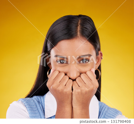 Portrait, wow and excited with a woman on a yellow background in studio looking shocked or in awe. Face, surprise and omg with an attractive young female standing hands over mouth in amazement Portrait, wow and excited with a woman on a yellow background in studio looking shocked or in awe. Face, surprise and omg with an attractive young female standing hands over mouth in amazement 131798408