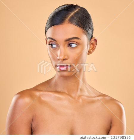 Beauty, face and skin of woman serious in studio for skincare, cosmetics, dermatology or makeup. Aesthetic female for self care, natural facial and collagen shine results on a brown background Beauty, face and skin of woman serious in studio for skincare, cosmetics, dermatology or makeup. Aesthetic female for self care, natural facial and collagen shine results on a brown background 131798555