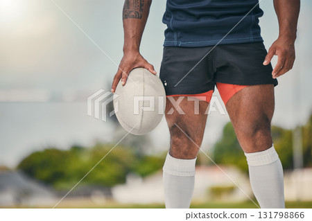 Rugby, man and ball, zoom on legs of strong, muscular male ready at winning game on field. Fitness, sports and professional sport player at practice match, workout or competition on grass at stadium Rugby, man and ball, zoom on legs of strong, muscular male ready at winning game on field. Fitness, sports and professional sport player at practice match, workout or competition on grass at stadium 131798866