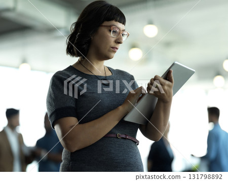 Technology, administration and woman with tablet reading email, sales or social media on web. Research, leadership and company ceo networking with online communication in management at startup office 131798892