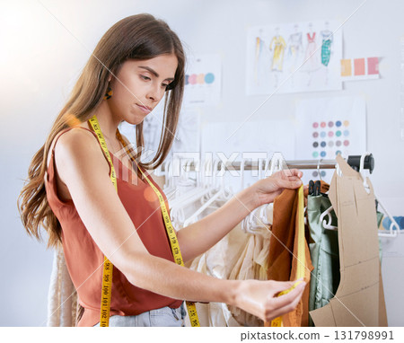 Fashion, designer and manufacturing with woman and tape in workshop studio for creative, clothes and tailor. Fabric, textile and planning with girl in factory for luxury, boutique and retail sales 131798991