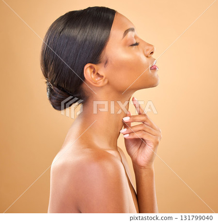 Face, beauty and skincare profile of woman in studio for cosmetics, dermatology or makeup. Aesthetic female .hand on skin for self care, natural glow or spa facial shine results on a brown background 131799040