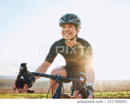 Cycling, fitness and happy with woman in park for training, workout and cardio health. Exercise, travel and freedom with female cyclist riding on bike in nature for adventure, journey and transport 131799083