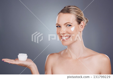 Cream, skincare mockup and portrait of woman on gray background for wellness, cosmetics and facial care. Beauty marketing, dermatology and girl with lotion, creme and anti aging product placement 131799229