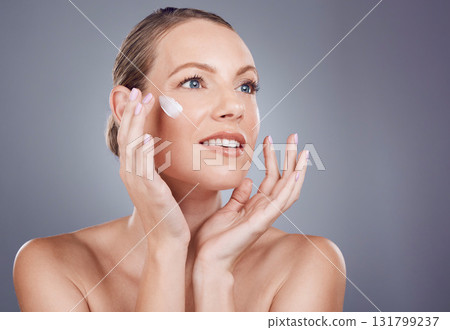 Skincare, cream and face of woman for beauty on gray background for wellness, cosmetics and facial treatment. Luxury spa, dermatology and happy girl with lotion, moisturizer and anti aging products Skincare, cream and face of woman for beauty on gray background for wellness, cosmetics and facial treatment. Luxury spa, dermatology and happy girl with lotion, moisturizer and anti aging products 131799237