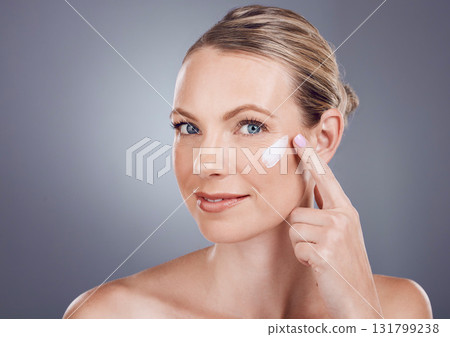 Skincare, beauty cream and portrait of woman on gray background for wellness, cosmetics and facial treatment. Luxury spa, dermatology and happy girl with lotion, face creme and anti aging products 131799238