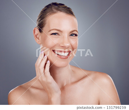 Beauty, face and woman in portrait with hand touching facial, dermatology and skincare on studio background. Cosmetic care, happy model and healthy skin with smile, natural cosmetics and wellness 131799239