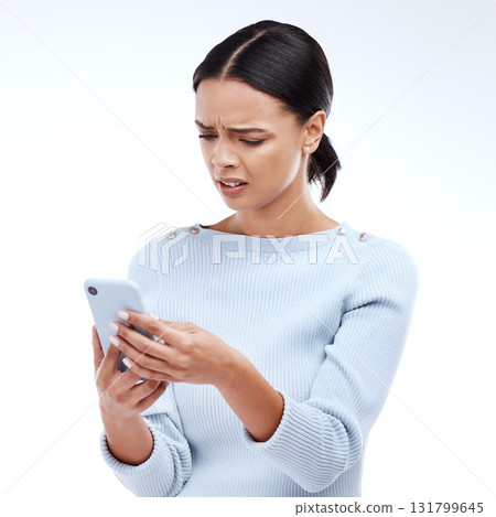 Confused, woman and phone in a studio reading a phishing, scam and fake news text. Isolated, white background and mobile texting of a young and gen z female with online and spam email with wtf Confused, woman and phone in a studio reading a phishing, scam and fake news text. Isolated, white background and mobile texting of a young and gen z female with online and spam email with wtf 131799645