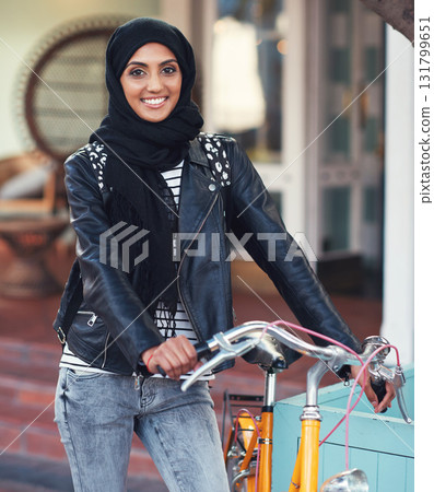 Muslim, woman and city portrait with bike for eco friendly transport, travel and smile with excited face. Happy islamic girl, gen z student and bicycle transportation with sustainability in metro 131799651