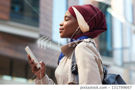 Happy, music and phone with black woman in city for relax, streaming and social media. Independent, internet and hijab radio with muslim girl listening to earphones for podcast, online and digital Happy, music and phone with black woman in city for relax, streaming and social media. Independent, internet and hijab radio with muslim girl listening to earphones for podcast, online and digital 131799667