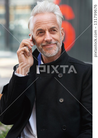City, phone call and mature man at office, success and confidence, happy legal advice. Ceo, lawyer or businessman on sidewalk outside court with smartphone, smile and crm or networking conversation. City, phone call and mature man at office, success and confidence, happy legal advice. Ceo, lawyer or businessman on sidewalk outside court with smartphone, smile and crm or networking conversation. 131799676