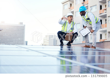 Solar energy, sustainability and engineer team on a rooftop to repair, program or install renewable power in a city. Sustainable, man and teamwork by technician for eco friendly electricity Solar energy, sustainability and engineer team on a rooftop to repair, program or install renewable power in a city. Sustainable, man and teamwork by technician for eco friendly electricity 131799805