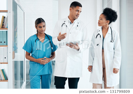 Nurse, doctors and walking with tablet talking and planning life insurance or medical research. Diversity women and man with mobile app for communication, online consultation and advice in hospital Nurse, doctors and walking with tablet talking and planning life insurance or medical research. Diversity women and man with mobile app for communication, online consultation and advice in hospital 131799809