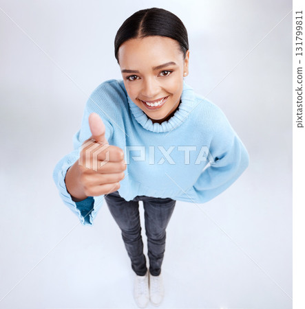 Portrait, thumbs up and above with a woman on a white background in studio for motivation or success. Winner, emoji and hand gesture with an attractive young female saying thank you to show support Portrait, thumbs up and above with a woman on a white background in studio for motivation or success. Winner, emoji and hand gesture with an attractive young female saying thank you to show support 131799811