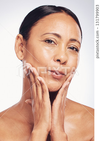 Skincare, glow and the portrait of a mature woman isolated on a white background in a studio. Happy, anti aging and a beauty model touching glowing skin, feeling softness and clear complexion Skincare, glow and the portrait of a mature woman isolated on a white background in a studio. Happy, anti aging and a beauty model touching glowing skin, feeling softness and clear complexion 131799903