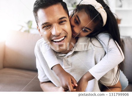 Family, portrait and hug by girl and father on sofa, happy and relax, playing and laughing in living room. Love, face and child embrace parent on couch, cheerful for day off, weekend or relationship 131799906
