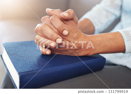 Bible, worship and hands of old woman in living room for religion, book and Christian faith. Spiritual, God and prayer with senior lady praying with holy text at home for wellness, believe and goal 131799919