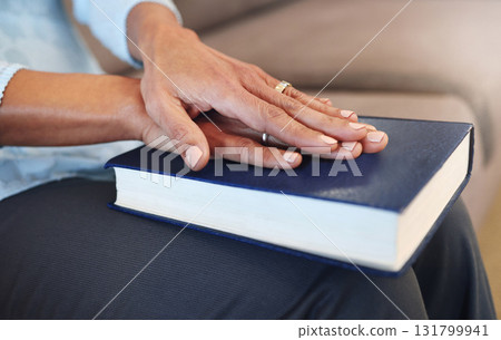 Bible, prayer and hands of old woman in living room for religion, book and Christian faith. Spiritual, God and worship with senior lady praying with holy text at home for wellness, believe and goal 131799941