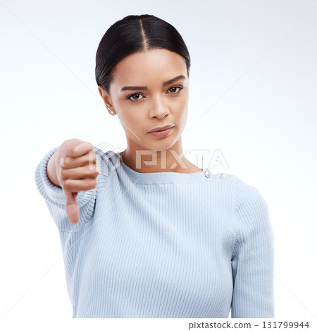 Thumbs down, woman and portrait with problem and no opinion and choice in studio. Isolated, white background and bad review of young female feeling disappointed from vote and emoji of fail hand sign Thumbs down, woman and portrait with problem and no opinion and choice in studio. Isolated, white background and bad review of young female feeling disappointed from vote and emoji of fail hand sign 131799944