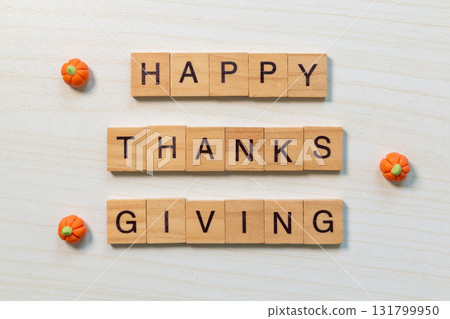 Wooden letter Happy Thanksgiving with mini pumpkins on light wood background Wooden letter Happy Thanksgiving with mini pumpkins on light wood background 131799950