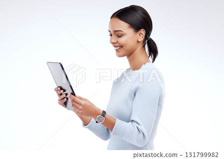 Woman, tablet and reading in studio by white background for planning, schedule and smile for website. Girl, student and excited on mobile touchscreen app for research, calendar or social network chat 131799982