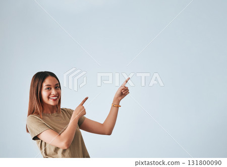 Woman, pointing hands and smile at space for mockup, studio advertising or product placement. Happy female on white background to show logo or branding with discount, promotion or sale announcement 131800090