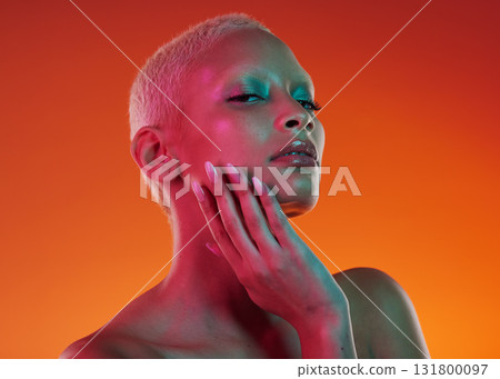 Skincare, beauty and portrait woman with neon face makeup and light in creative advertising on orange background. Cyberpunk, art and model isolated for skin care and futuristic mockup space in studio Skincare, beauty and portrait woman with neon face makeup and light in creative advertising on orange background. Cyberpunk, art and model isolated for skin care and futuristic mockup space in studio 131800097