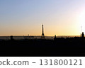 Stunning view of the Eiffel Tower and silhouettes of houses at sunset 131800121