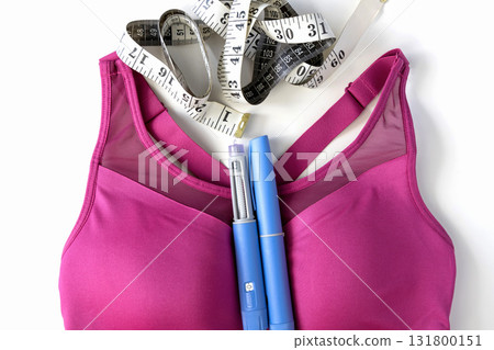 Concept of losing weight with the diabetes drug Ozempic. Sports top and Ozempic syringe pen. 131800151