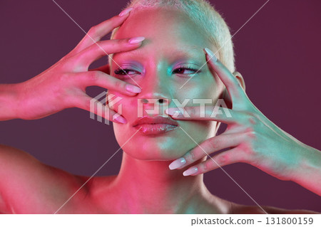 Neon makeup, woman with hands in face, skincare and lights for creative advertising on studio background. Cyberpunk, fantasy girl and art model isolated for skin care and futuristic mock up space. 131800159