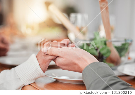 Family, dinner and party, hands together for prayer, gratitude for food and love, celebration and holiday. Worship, thank God and relationship, hungry people with meal and social event or gathering 131800210