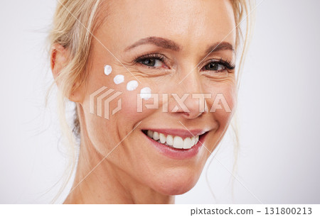 Skincare, face cream and portrait of mature woman in studio for wellness, beauty and care on grey background. Facial, product or sunscreen by lady relax in luxury, cosmetic and lotion while isolated 131800213