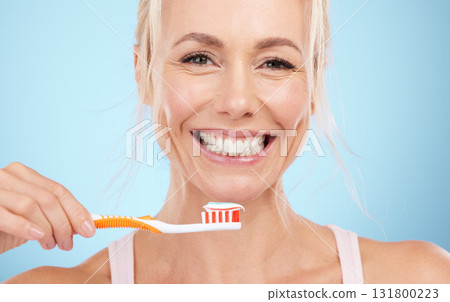 Portrait, mature woman and brushing teeth isolated on blue background in dental, mouth or orthodontics healthcare. Beauty model or happy person face for toothbrush product and toothpaste in studio 131800223