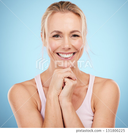 Woman, beauty and face with teeth in portrait, dental and skincare with veneers, oral care and wellness on blue background. Health, hands and smile, natural cosmetics with facial and orthodontics Woman, beauty and face with teeth in portrait, dental and skincare with veneers, oral care and wellness on blue background. Health, hands and smile, natural cosmetics with facial and orthodontics 131800225