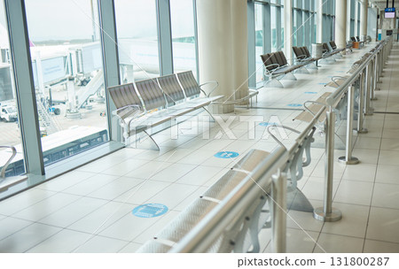 Airport, lounge chairs and terminal waiting room for global travel, covid regulations or immigration journey. Empty airplane lobby, seat or space of commercial flight, building interior or background Airport, lounge chairs and terminal waiting room for global travel, covid regulations or immigration journey. Empty airplane lobby, seat or space of commercial flight, building interior or background 131800287