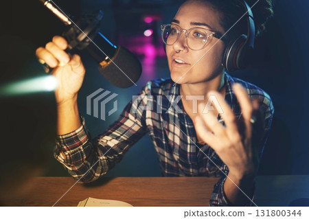 Podcast, microphone and live streaming woman speaking, advice or broadcast on gen z platform at night. Serious influencer person with voice talking on mic for news, politics or media report on radio 131800344