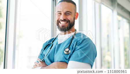 Doctor in portrait, man with arms crossed and healthcare, smile with confidence at hospital with pride and help. Happy medical professional, trust and expert at clinic with scrubs and medicine 131800361