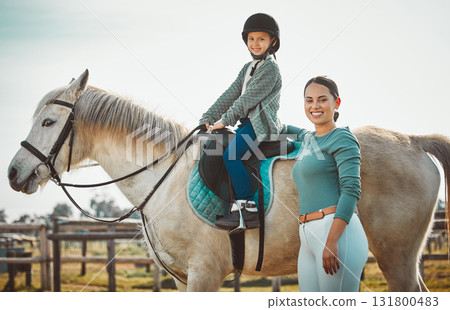 Portrait of woman standing, child on horse and ranch lifestyle with smile and equestrian sports on field. Countryside, rural nature and farm animals, mother teaching girl to ride stallion in USA. Portrait of woman standing, child on horse and ranch lifestyle with smile and equestrian sports on field. Countryside, rural nature and farm animals, mother teaching girl to ride stallion in USA. 131800483