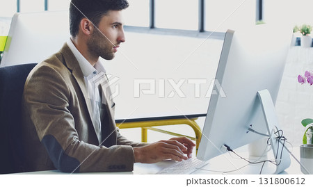 Research, planning and serious with businessman at computer for designer, idea and email. Technology, internet and creative with person typing in digital agency startup for data, vision and focus 131800612