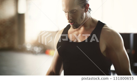 Workout, exercise and strong man training in a gym or fitness club muscle building for health or wellness. Sweat, endurance and sports person or athlete serious, focus and determined with motivation Workout, exercise and strong man training in a gym or fitness club muscle building for health or wellness. Sweat, endurance and sports person or athlete serious, focus and determined with motivation 131800655