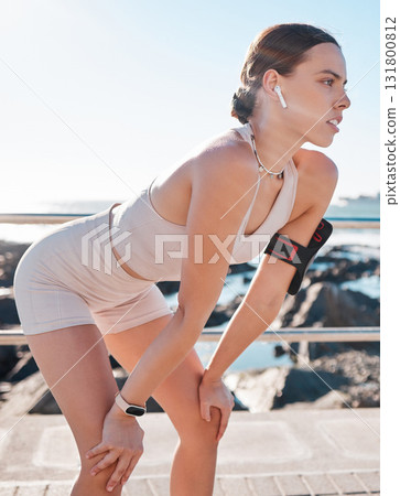 Fitness, woman and break after running exercise, workout or cardio training in breathing recovery at beach. Active female runner relaxing to breathe for endurance or regenerate stamina by ocean coast Fitness, woman and break after running exercise, workout or cardio training in breathing recovery at beach. Active female runner relaxing to breathe for endurance or regenerate stamina by ocean coast 131800812