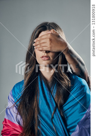 Surprise, cover and woman with bisexual flag isolated on a grey studio background. Love, freedom and girl in support of LGBT community with person covering eyes to be surprised for pride on backdrop Surprise, cover and woman with bisexual flag isolated on a grey studio background. Love, freedom and girl in support of LGBT community with person covering eyes to be surprised for pride on backdrop 131800918