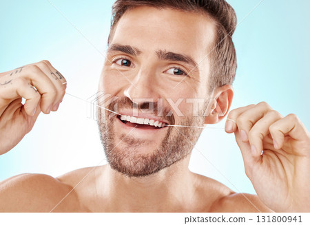 Floss, teeth and portrait of man isolated on blue background for mouth cleaning, smile or beauty health. Mature model or dental person with product in tooth, gum and dentist healthcare in studio Floss, teeth and portrait of man isolated on blue background for mouth cleaning, smile or beauty health. Mature model or dental person with product in tooth, gum and dentist healthcare in studio 131800941